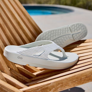 OORIGINAL LIMITED SANDAL - COSMIC GRAY BAMBOO on chair by pool